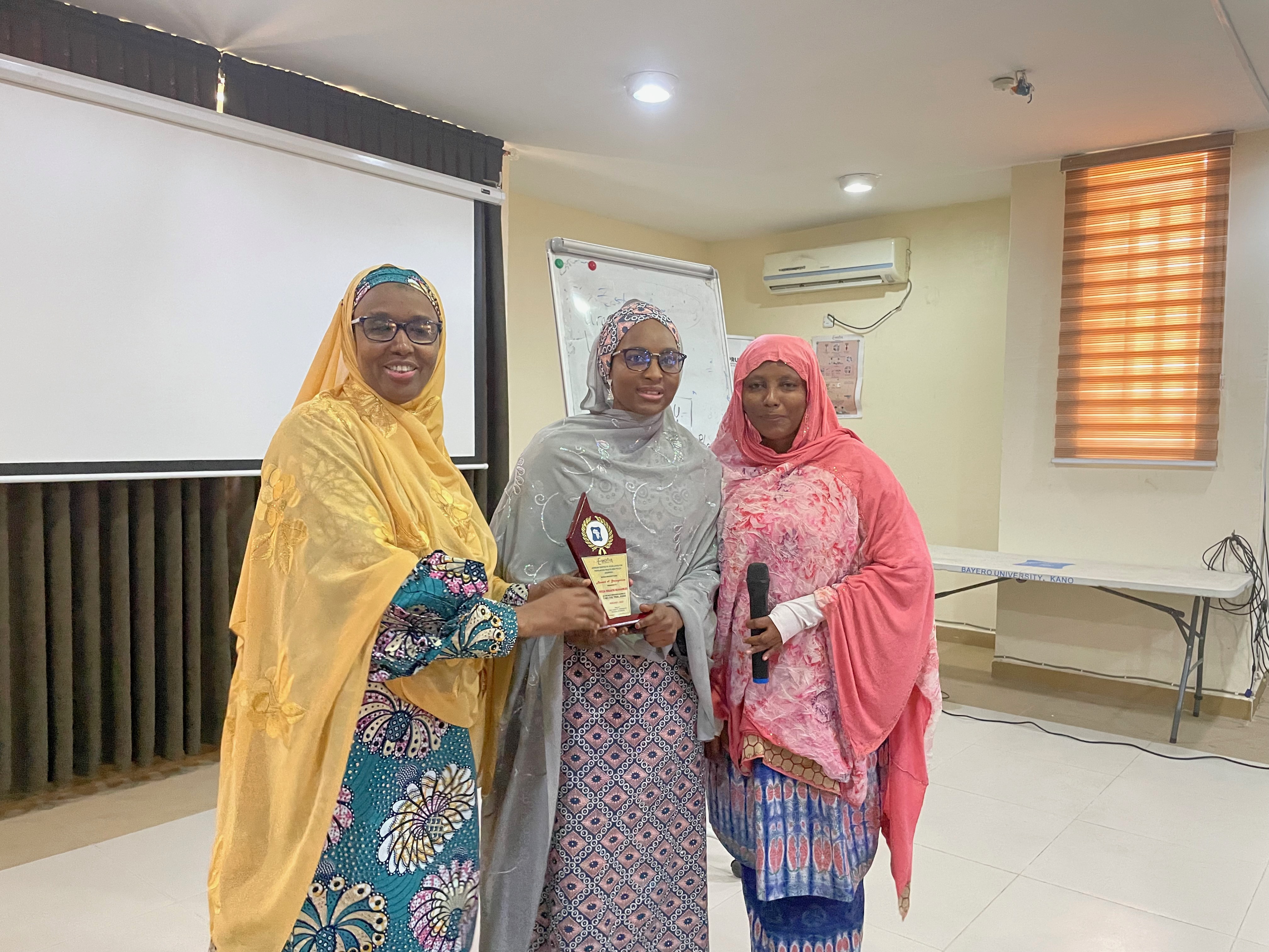 ACEPHAP Director, Prof. Galadanci (1st left) with one of the best researcher (middle) displaying the award