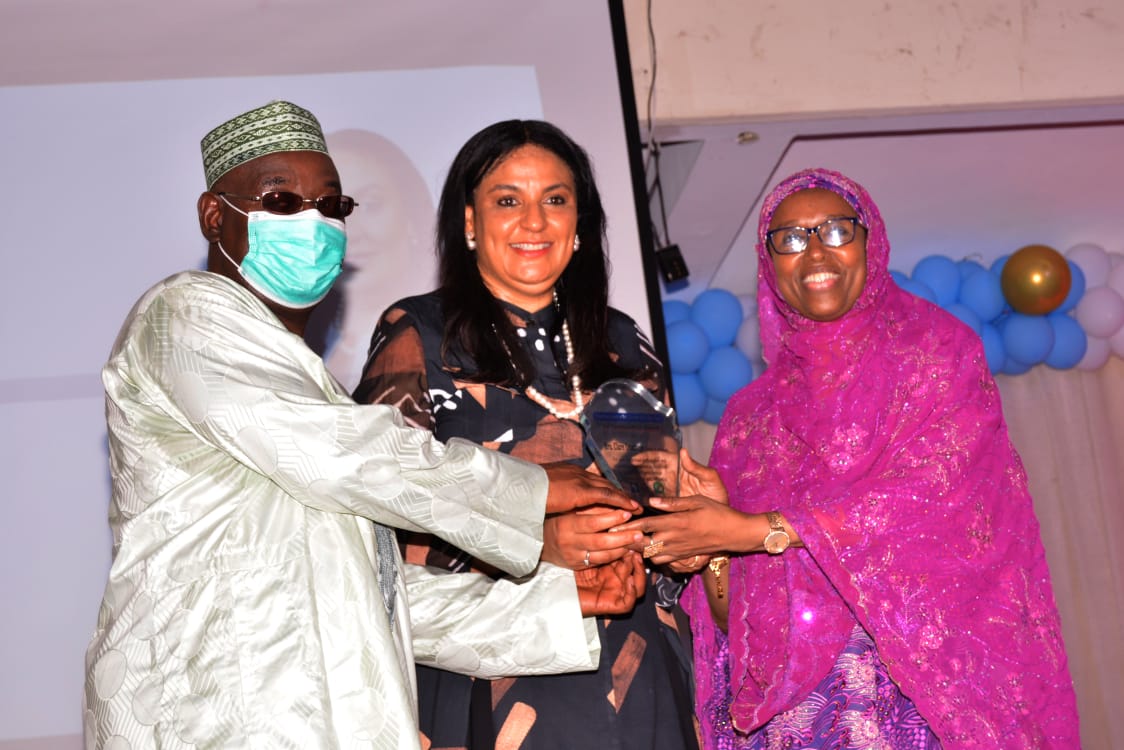 The Guest Lecturer, Mrs. Clare Omotseye (middle) receiving her award from Prof. Hamisu Salihu and assisted by Prof. Hadiza Galadanci (right)